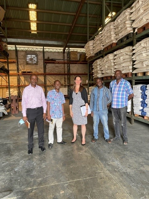 A group of five Alltech LTD employees standing together in a warehouse in Lagos, Nigeria.