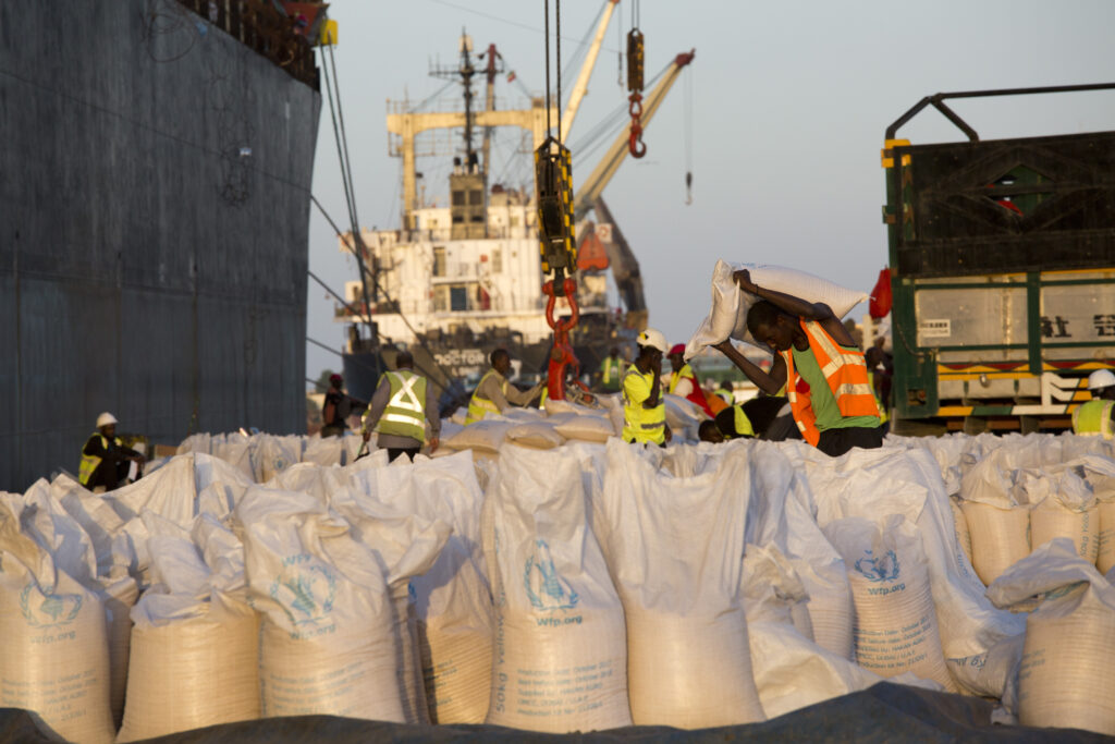 Porters load food aid onto a WFP cargo ship, Levroso, in Berbera port, Somaliland.