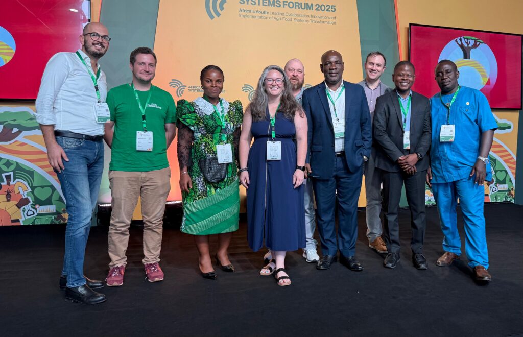 Nine people pose for a photo.