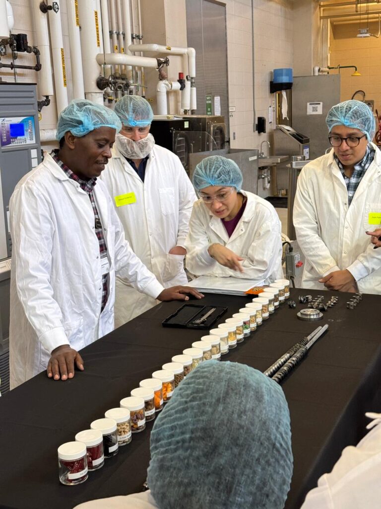 Course participants look at samples on a table.