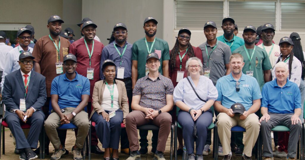 A group of people pose for a photo with the back row standing and the front row sitting.