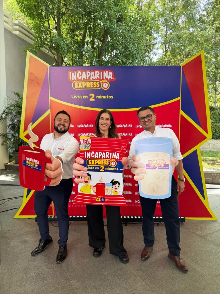 Three people pose together for a photo.