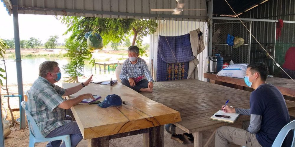 From Left: CAST Technical Advisor Len Rogers follows social distancing and hygiene practices as he shares recommendations on feeding practices and discusses current market conditions with fish farm owner Mr. Sok Raden and CAST Technical Specialist David Samveana at  Mr. Raden’s farm.